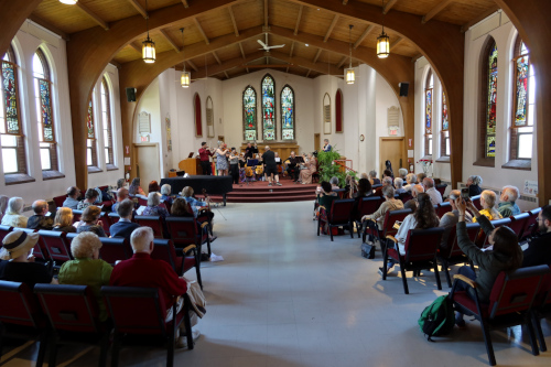 An ensemble of musicians playing together in a church.